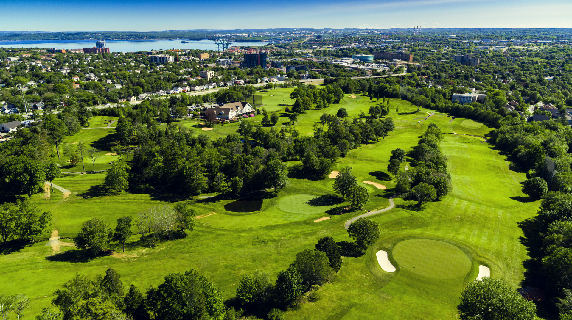 Old-Course---Drone-2019_Golf-course-with-green-landscaping-and-water-behind-Ashburn-GC